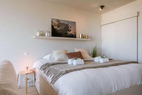 a bedroom with a bed with two pumpkins on it at Huswell - Modern studio with magnificent seaview in Koksijde