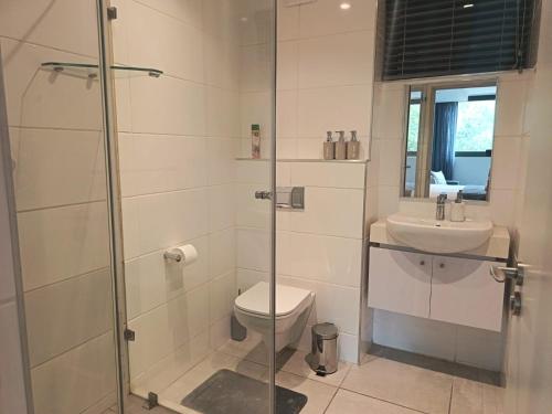 a bathroom with a shower and a toilet and a sink at Zimbali Lakes Boulevard Suites 157 in Ballito