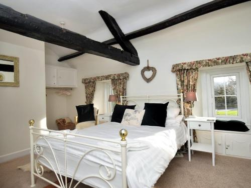 a bedroom with a white bed and a desk at 2 Bed in Ullswater SZ276 in Stainton