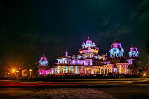 a building lit up with purple lights at night at Hotel O Greenwood in Rishop