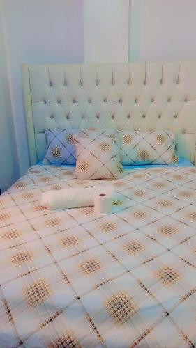 a bed with a pillow and a roll on it at Ekebute BnB in Mombasa