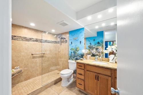 a bathroom with a shower and a toilet and a sink at Lahaina Shores 413 · LS 413 Breathtaking Beachfront Remodeled St in Wainee