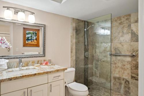 a bathroom with a shower and a toilet and a sink at Lahaina Shores 306 · LS 306 Dream Maui Studio by the Beach Pool in Wainee