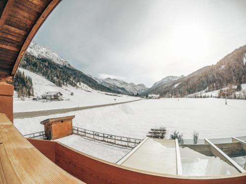 a room with a view of a snow covered lake at Cozy holiday apartment close to the slopes in Kleinarl
