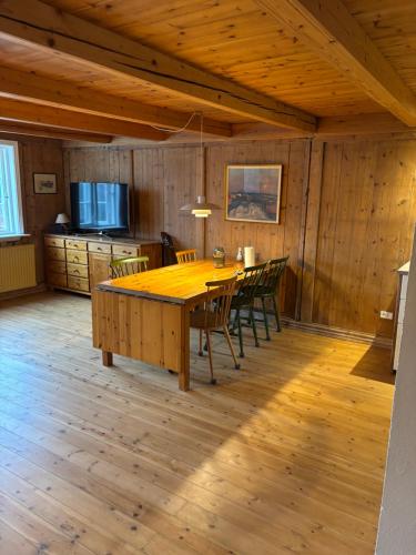 a dining room with a wooden table and chairs at Beautifully restored traditional home in old town Tórshavn in Tórshavn
