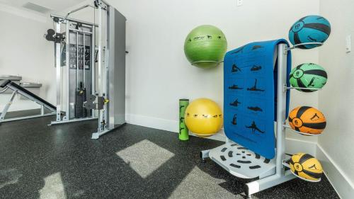 a room with a gym with balls and weights at Lovely Apartment in Austin shopping Dining in Cedar Park