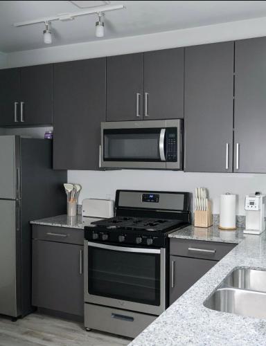 a kitchen with a stove and a microwave at Townhome in North Austin in Austin