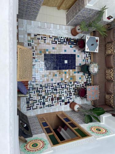 a bathroom with a tile fireplace in a room at Riad La Mentha Panoramic Terrace in Fes Medina in Fez
