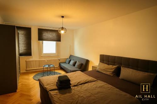 a bedroom with a bed and a couch at AIL Hall City in Schwäbisch Hall
