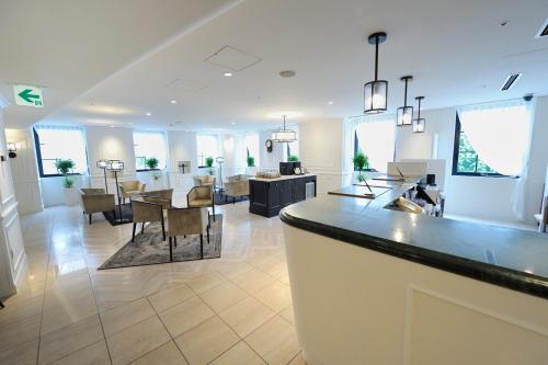 a kitchen and dining area of a home with a dining room and a living room at Court Hotel Shin-Yokohama in Yokohama