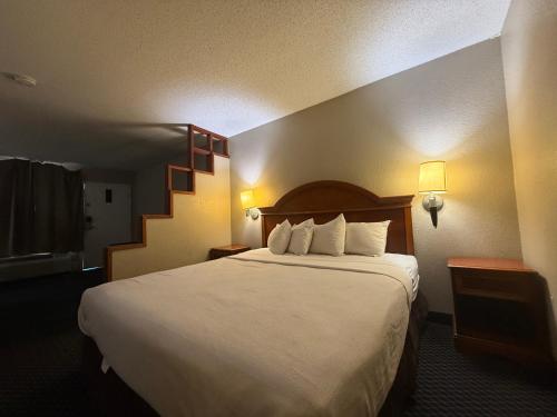 a hotel room with a bed and a staircase at Homegate Studios & Suites San Antonio Medical Center in San Antonio