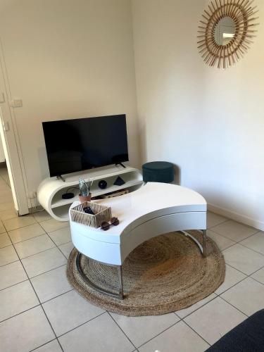 a white piano sitting in a living room at Charming house with terrace in Laval