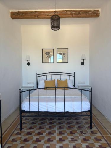a bedroom with a black bed with yellow pillows at 4 Borgo Vilhena - Home in Floriana in Il-Furjana