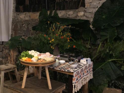a table with a plate of food and a camera at Le Petit Home in Dồng Văn