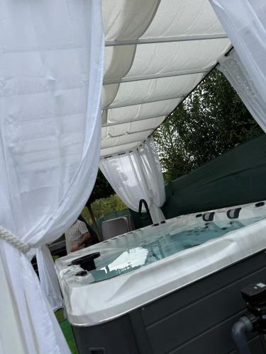 a hot tub in a tent with a canopy at Anna Chalet in Breaza de Sus