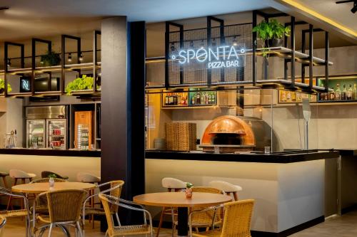 a restaurant with two tables and chairs and a counter at ibis Sao Paulo Paulista in Sao Paulo