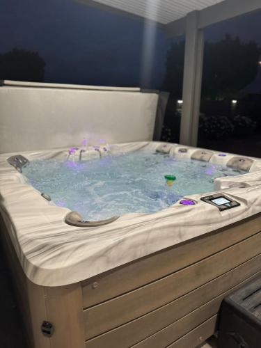 a jacuzzi tub in a room with a window at Heated Pool, Hot Tub, Games & more! in Mesa