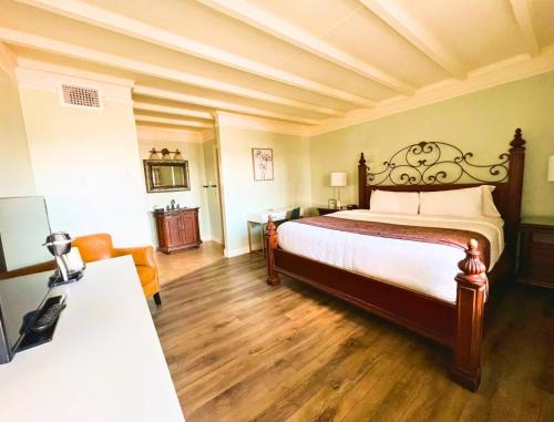 a bedroom with a large bed and a table at Bayfront Inn in Saint Augustine