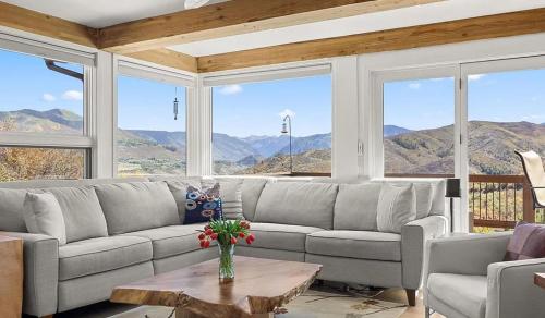 a living room with a couch and a table at Private Aspen Haven Views in Woody Creek