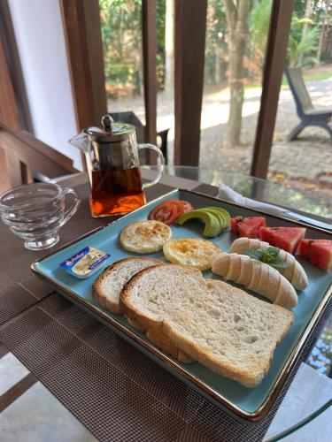 a plate of bread and fruit on a table at Serenity Villa in Dickwella