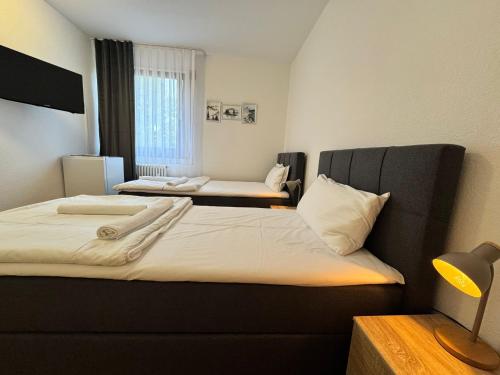 a hotel room with two beds and a couch at Orex Hotel in Waiblingen