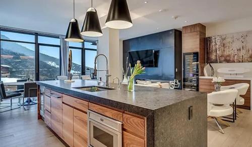 a kitchen with a large island in the middle at Modern Alpine Escape Sophistication in Snowmass in Snowmass Village