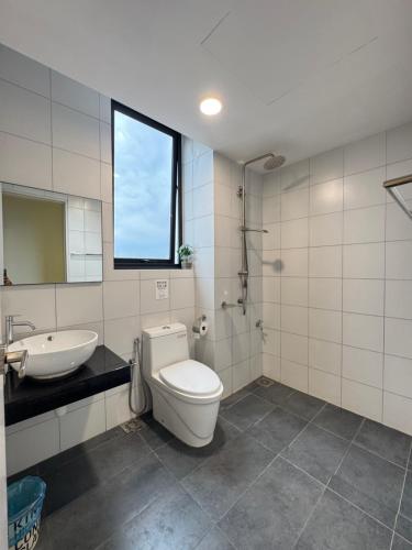 a bathroom with a toilet and a sink at Chambers Suites Kuala Lumpur by AFA in Kuala Lumpur
