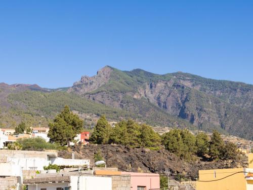 a view of a city with mountains in the background at Live Guimar los Piramides in Chabaica