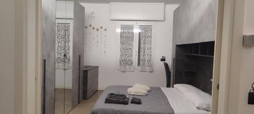 a bedroom with a bed with towels on it at Bariola Apartment in Caronno Pertusella