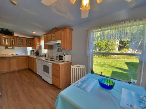 a kitchen with a blue table in a room at Serendipity in Saint Ignace