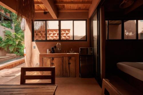 a room with a sink and a kitchen with windows at Punta Navi - Adults only - Boutique hotel in Puerto Escondido
