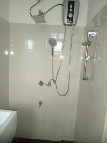 a bathroom with a shower with a shower head at Ananthaya- the infinity in Wadduwa