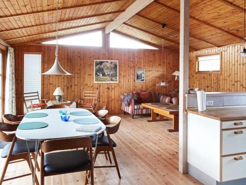 a kitchen and living room with a table and chairs at 4 person holiday home in Store Fuglede in Store Fuglede