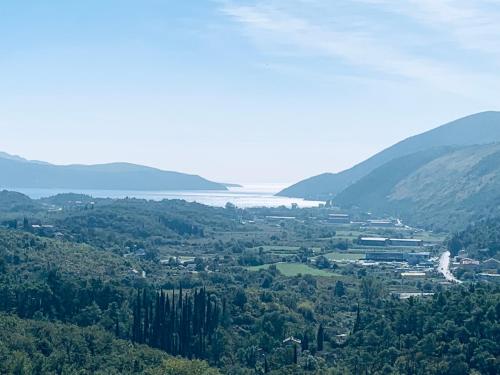a view of a valley with trees and a body of water at Iris Lucici Aparts in Herceg-Novi