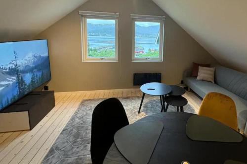 a living room with a large flat screen tv at 1 Bed Loft Sleeps 4 -Hot Tub Sauna & Pets Ok in Stokmarknes