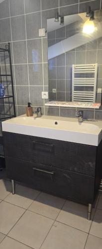 a bathroom with a sink and a mirror at Cœur de Provence in Marignane