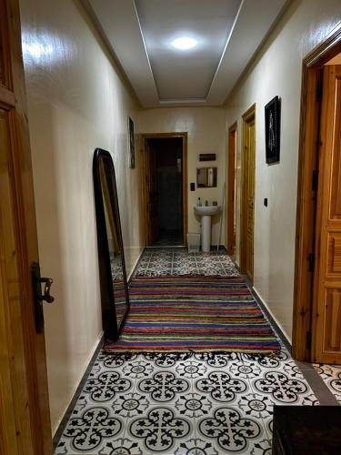 a hallway with a mirror and a bathroom at Dar Kawtar in Marrakesh