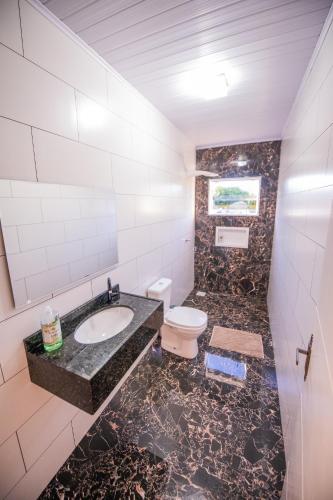 a bathroom with a sink and a toilet at Pousada San Jose in Pântano Grande