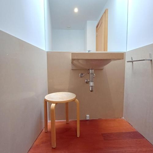 a stool in a bathroom with a sink at Tasteful Beach Getaway with Private Terrace in Matosinhos
