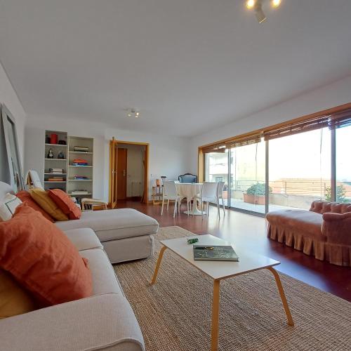a living room with a couch and a table at Tasteful Beach Getaway with Private Terrace in Matosinhos