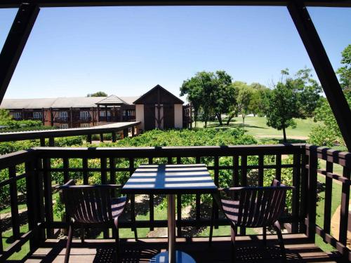 a table and chairs on a deck with a view at Novotel Vines Resort Swan Valley in Upper Swan