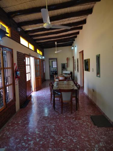a living room with a table and chairs in it at Hostal Dña Tinogasta Casa de Adobe in Tinogasta
