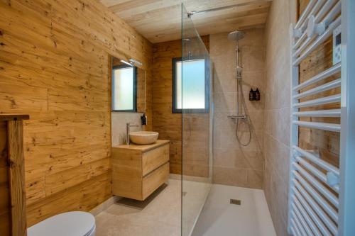a bathroom with a shower and a toilet and a sink at Le Pech Eternel - Lodge Spa Cedres in Sarlat-la-Canéda
