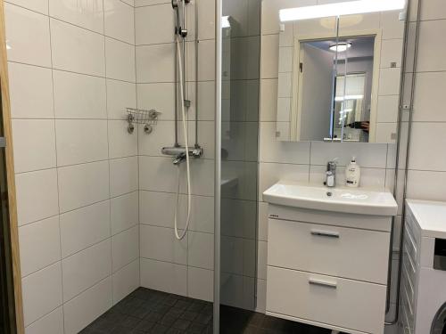 a bathroom with a shower and a sink at Spacious Apartment for 6 with Sauna in Kemi
