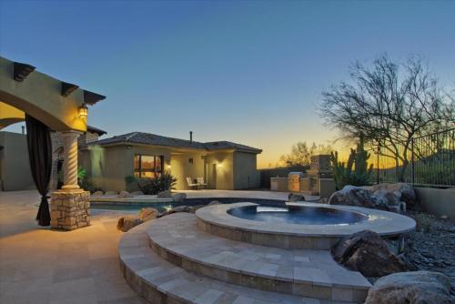 a backyard with a fire pit and a house at Romantic 4BR Hacienda with Pool, Spa and Close to Town in Cave Creek