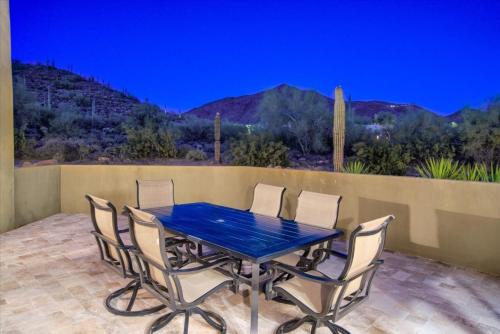 a blue table and chairs on a patio at Romantic 4BR Hacienda with Pool, Spa and Close to Town in Cave Creek