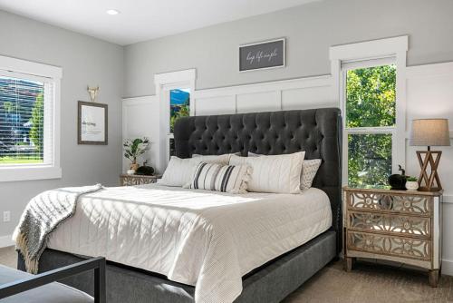 a bedroom with a large bed and two windows at Boardwalk in Garden City