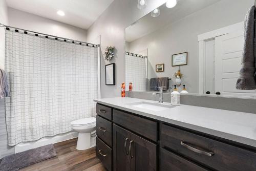 a bathroom with a sink and a toilet at Boardwalk in Garden City