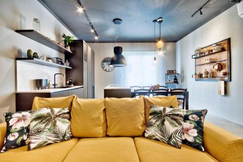 een woonkamer met een bank en een keuken bij The Cove in Sliema