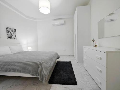 En eller flere senge i et værelse på Seaview Escape